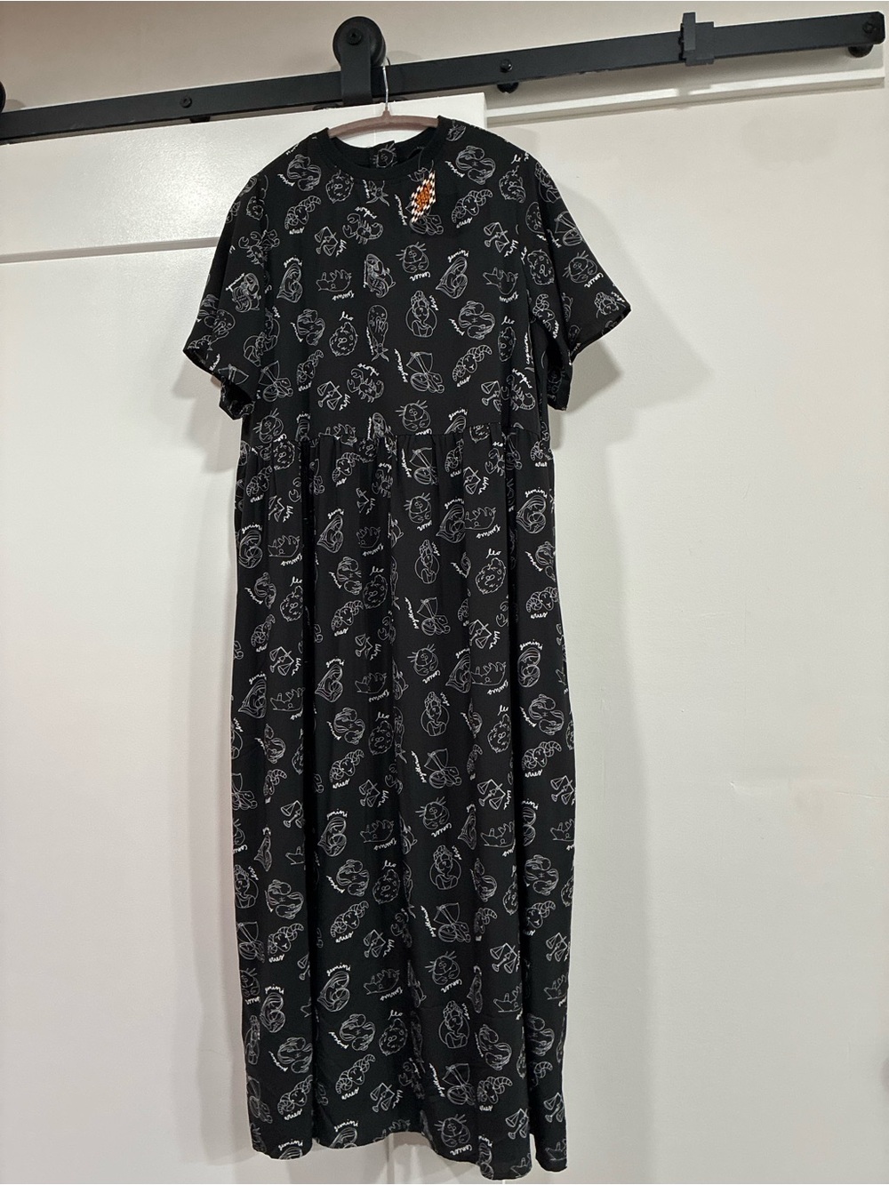 Dressed in Lala black midi dress with pockets. white zodiac print.